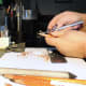 Sharpening my charcoal pencils with an X-acto knife.