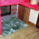 Padded cat flap insulator upholstered in carpet, which doubles as cat bed.