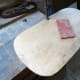 Sanding smooth the edges of the plywood back.
