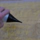 Wetting the bubble wrap to facilitate easy movement on the surface.