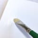A flat paint brush can also be used to apply gesso.