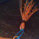 Tassel slipped onto yarn and glued in place.