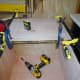 Lid held in place with clamps while it’s being hinged to the fixed back section of the cabinet top