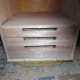 Plinth drawer assembled and slotted in place between the wheels, under the base of the cabinet