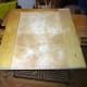The scrap wood cut to size and fitted on the underside of the base