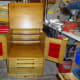 Completed sewing machine cabinet in workshop with doors and lid open