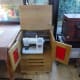 Completed sewing machine cabinet in Conservatory with doors and lid open