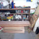 The Meranti planks brought back to Bristol from Portsmouth, England; with a jig on the right my friend made for routing divider slots in the drawers.