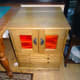 Sewing machine cabinet with view of top lid and piano hinge