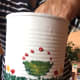 The golden oil paint was added to the green of the painted flower pots. Red dots were added on top of the pots.