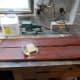 Quick hand sanding after second coat of wood stain is dried, for smooth finish; then cleaned with white spirit prior to polishing.