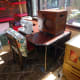Repurposed table in situ with sewing machine and overlocker in its protective box laid on table top.