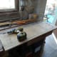 Screw countersunk into plywood, out of way of belt sander.