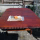 Light hand sanding of table top prior to final coat of wood stain.