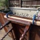 Gluing and screwing the arm supports to the table’s side skirts.