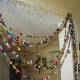 You can see the belt I nailed to the wall on top, with loops I made from string to hold up the curtain. I drape it to the side until I'm finished filling up the belt with more bead strands and add pics to show progress.