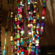 My own beaded curtain is made of glass, plastic and handmade polymer beads, along with fabric to fill in spaces, all threaded with fishing line.