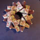 Slip the eighth tile under the very first one. Use a dab of glue. The wreath is complete.