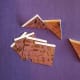 Cut seven two-inch tiles from paper of your choice. Fold the seven tiles in half diagonally, as shown above.