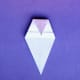 Turn the ghost over. This is now the back of the figure. The head starts at the new double fold. Fold down the top tip to form the top.