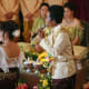 Two Khmer singers, representing heavenly beings, symbolically cleanse the wedding couple of their past.