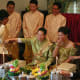 They simulate cutting hair and perfuming the couple while telling jokes and teasing them.