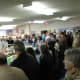 The blessing. As full as the room was, more people came in part way through the blessing and added their baskets as well.