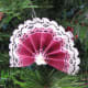 A completed Victorian fan ornament hung on the tree.