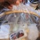Gather and tuck plastic wrap in desired position, either at the top or at the back of the basket.