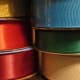 Assorted ribbons with bold color and texture beautifully accent a gift basket.