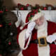 Santa wears a red suit and hat and brings gifts to good boys and girls.
