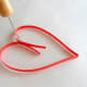 Bend both ends to make a heart outline.