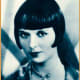 Publicity photo of Louise Brooks from short biographical sketch-book Stars of the Photoplay, 1930 (public domain).
