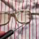 If that doesn't work, use a screwdriver or awl on the lens edge.