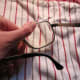 Place on a cloth to cushion, and apply pressure to lens.