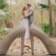 A couple kissing with wedding ring held between two high heeled shoes