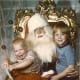 What a priceless expression on Santa's face! And look at the older brother who is enjoying the whole experience!