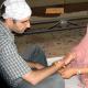 Tying the rakhi.
