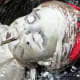 Here I paint the doll's head white after covering its eyes with tape.