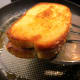 Once it's ready, pick the French toast up with a spatula.