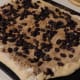 The rolled out dough topped with raisins and walnuts