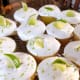 Top the frosting with fresh slices of lime and grated lime zest.