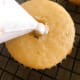 I like to remove a bit of cake from the center of each cupcake top fill with frosting.