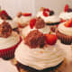 Scrumptious chocolate cupcake with vanilla frosting, freshly sliced strawberries and Ferrero Rocher chocolate hazelnut
