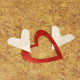 Continue gluing your hearts to your twine, alternating sparkle hearts with book page hearts.