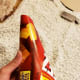 Roll a rectangular piece of cardboard into a cone shape to create a form for your hat.