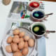 While the eggs are submerged in the dye mixes, dunk them up and down using spoons.