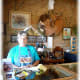 Candy Shores behind a jewelry counter inside of her store