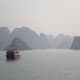 Boat sailing off into Halong Bay, Vietnam.