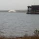 View from Presque Isle Park of Northern Michigan University Superior dome and of part of a working iron ore dock. Trains bring ore from a mine and ships take it away.